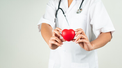 World heart day concept of woman doctor hand holding red heart