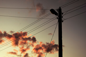 power lines on the background of the sunset sky with clouds
