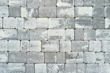 Cobblestone texture. The sidewalk tile is evenly folded. Gray cobblestones close up.