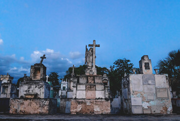 Old graveyard tombs with corsses and angel statue at the cemetery 'Cementerio General' in Merida, Yucatan, Mexico