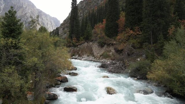 Mountain river in the Ala-Archa gorge in Kyrgyzstan. Stormy streams of water in the mountains.