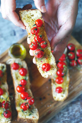 Selective focus. Delicious bruschetta with olive oil and cherry tomatoes. Italian Cuisine