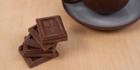 Chocolate and cup of coffee espresso on wood background