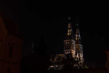 
street lighting at the Prague fortress Vysehrad.

light from street lighting through the gate of...