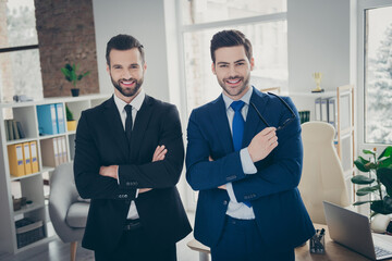 Fototapeta premium Portrait of two nice attractive content smart clever ambitious experienced cheerful cheery men expert specialist employer hr ceo boss chief at industrial loft light white interior work place station