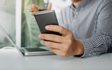 Digital marketing media in virtual screen.businesswoman hand working with mobile phone and modern compute with VR icon diagram at office in morning light