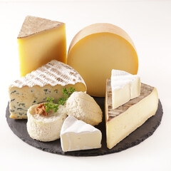 variety of cheese on platter isolated on white background