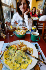 Teenage girl talking while having brunch in a restaurant