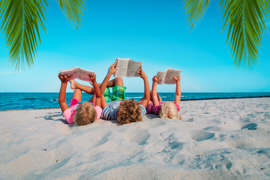 kids -boy and girls- read books on beach, family vacation