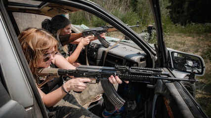 Military team of attractive female soldiers had shooter courses on shooting range. Shooting from...