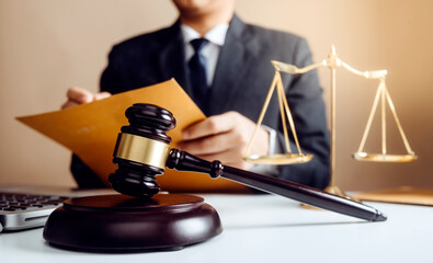 Business and lawyers discussing contract papers with brass scale on desk in office. Law, legal...