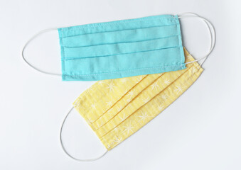 Homemade protective face masks on white background, top view