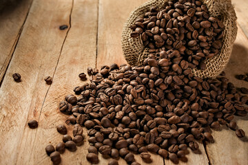 coffee beans in rustic bag rustic wooden background in top view with copy for text