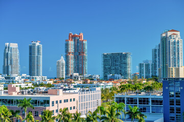 Fototapeta na wymiar Miami Beach skyscrapers and palms from MacArthur Causeway, aerial view on a sunny day