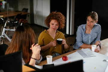 Businesswomen working on a new project. Colleagues discussing about problem they have to solved.