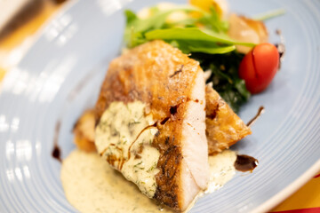 Sea bass fillet steak with lemon sauce served with vegetable