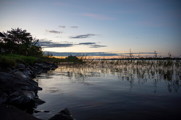 sunrise over the lake when the sky is covered with rain clouds