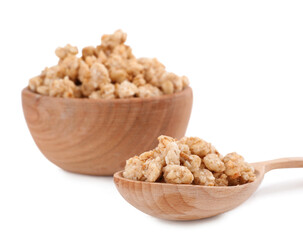 Tasty crispy granola in wooden bowl and spoon on white background