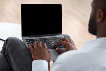 Unrecognizable African American Man Using Laptop With Black Blank Screen, Mockup Image