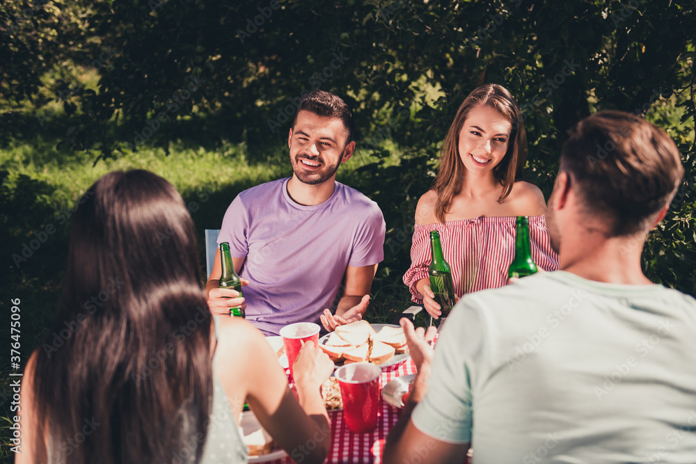 Sticker Back rear spine view photo of four buddies girls guys enjoy have fun summer vacation sit table eat feast drink bottle beer talk speak outside