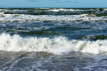 Sea coast. Tides and storms at sea. Waves on the Baltic Sea. Deserted seashore.