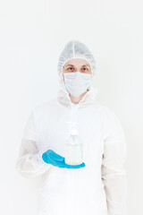 A man in a protective suit holds an antibacterial antiseptic gel for hand disinfection. Health care prevention during an outbreak of the flu virus and a coronavirus epidemic