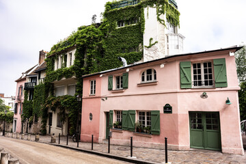 In Paris, France, ivy grows along the exterior of a beautiful building in Montmartre.