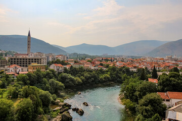 Fototapeta na wymiar The Neretva River upstream of the arched Old Bridge in Mostar,