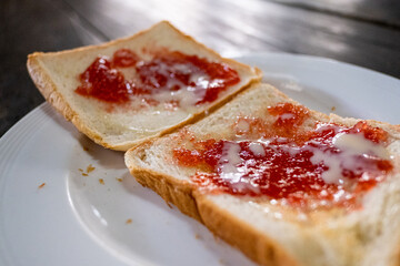 Breakfast fast food bread with strawberry jam