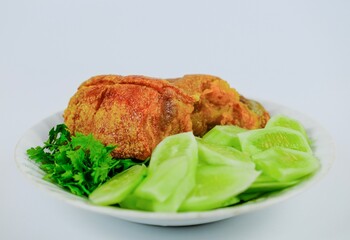 The crispy pork serve with fresh vegetable photo on the white background