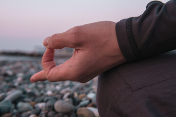 the guy sits on the seashore in the lotus position and meditates