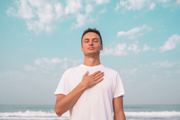 the guy sits on the seashore and meditates.