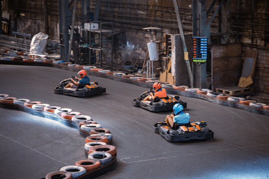 Three Guys Racing With Go Karts Indoors