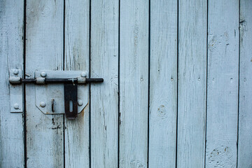 A wooden fence, a door. White vertical boards