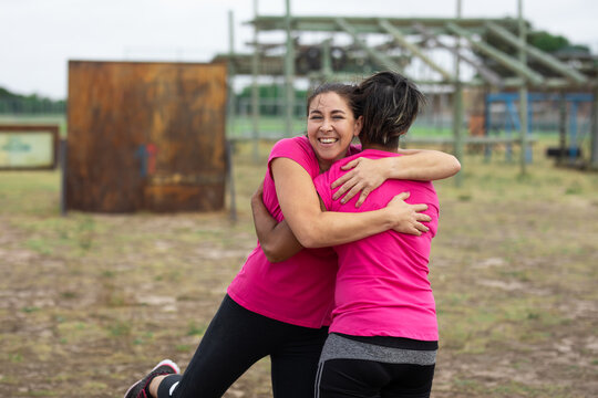 Two woman hugging each other at boot camp