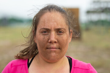 Portrait of woman with dirt on her face at boot camp