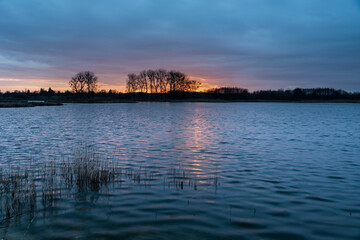 Sunset and colorful clouds over the lake