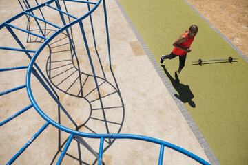 High angle view of man with prosthetic leg running in park