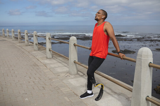 Black African American Man with prosthetic leg standing on the promenade - Powered by Adobe