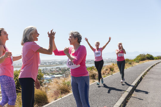 Two woman high fiving each other