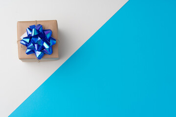 Top view of gift box with ribbon on blue background