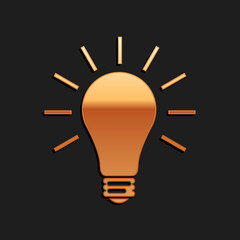Gold Light bulb with rays shine icon isolated on black background. Energy and idea symbol. Lamp electric. Long shadow style. Vector.
