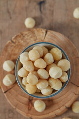 macadamian nuts on dark wooden surface