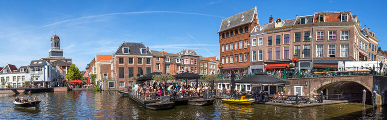 Leiden, Netherlands: sunny afternoon along the canals of the Aalmarkt. Terraces are filled with...
