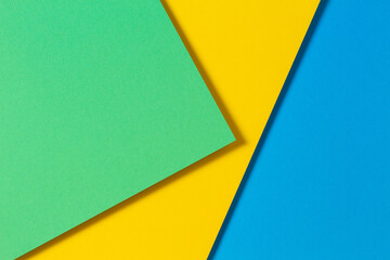 Abstract color papers geometry flat lay composition background with blue, yellow and green color tones