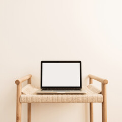 Laptop with blank screen on wicker bench against white wall. Minimal work / business / interior...