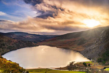 Dramatic sunset at Lake Lough Tay or The Guinness Lake in County Wicklow where Vikings village,...