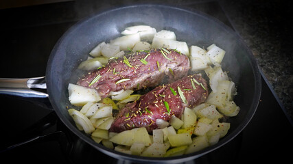 cooking at home - roasted game meat , fillets from a red deer calf