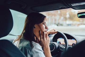 Young woman talking on phone during car trip