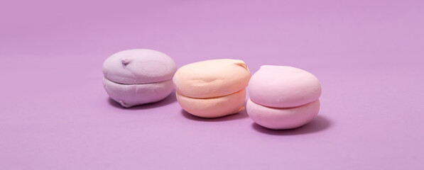 Obraz na płótnie Canvas airy sweet vanilla marshmallow pastel color on pink purple background, banner